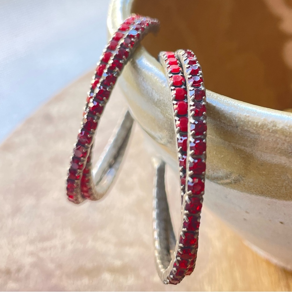 Red rhinestone open hoop earrings with posts.